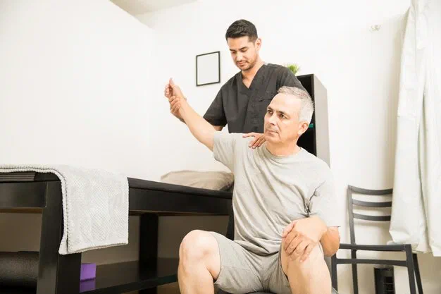 Physical therapist performing gentle joint mobilization on a patient's shoulder at Root Therapy and Wellness in Bozeman, Montana