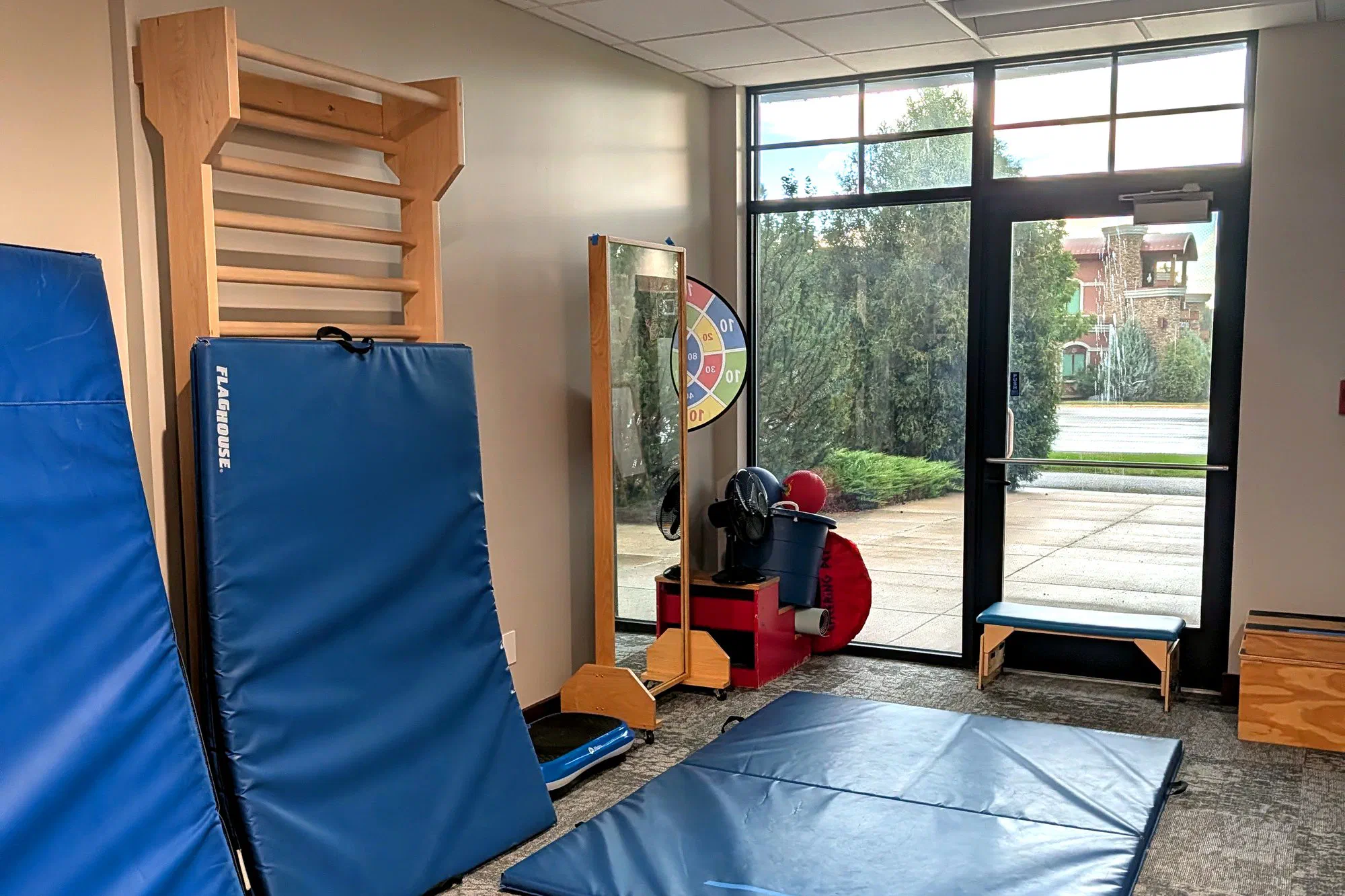 Pediatric therapy gym with wall bars and floor mats at Root Pediatrics in Bozeman, Montana