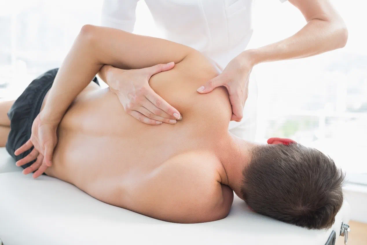 Therapist providing gentle, whole-person care for a fibromyalgia patient at Root Therapy and Wellness in Bozeman, Montana
