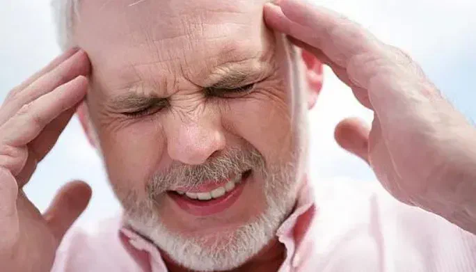 Physical therapist providing gentle upper-neck mobilization for a migraine patient at Root Therapy and Wellness in Bozeman, Montana
