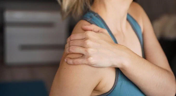 Physical therapist performing shoulder mobilization for a rotator cuff injury at Root Therapy and Wellness in Bozeman, Montana